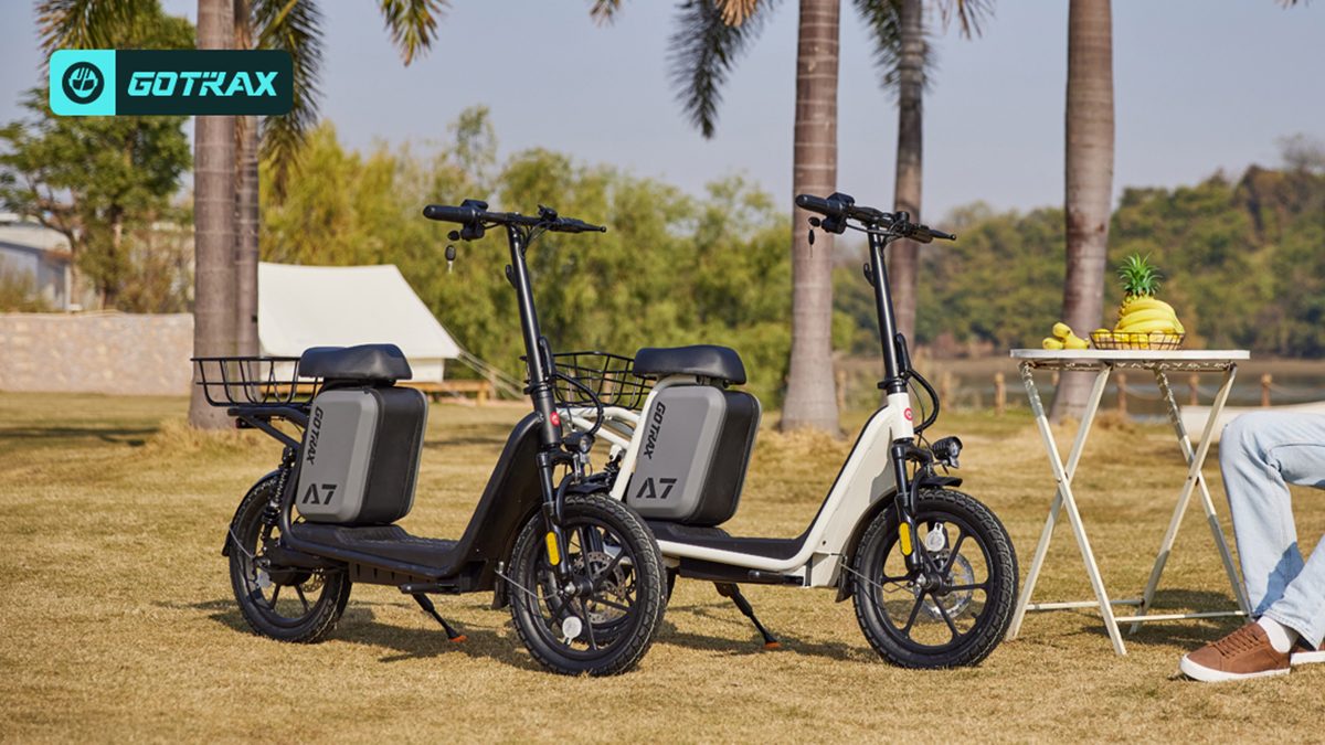 Two scooters parked on grass