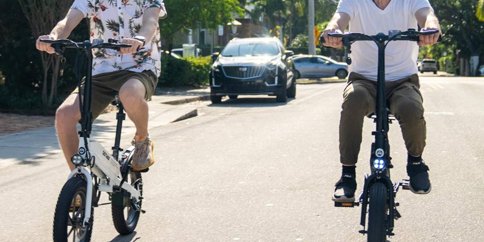 Two men riding bicycles on a street