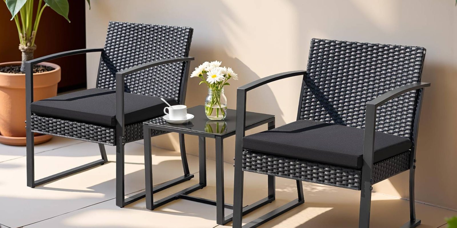 A table and chairs with a vase of flowers