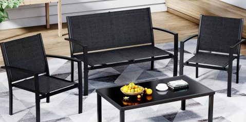 A black bench with a bowl of fruit on a table