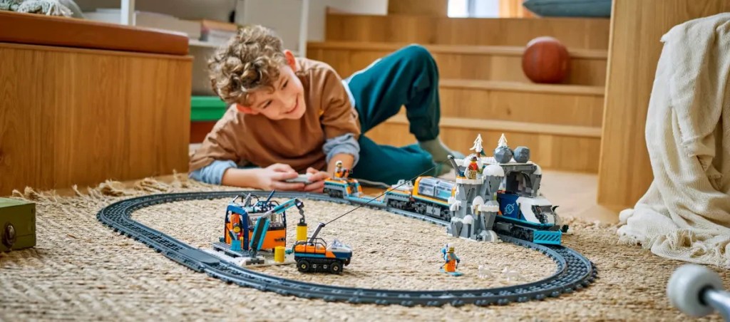 A boy playing with toy train