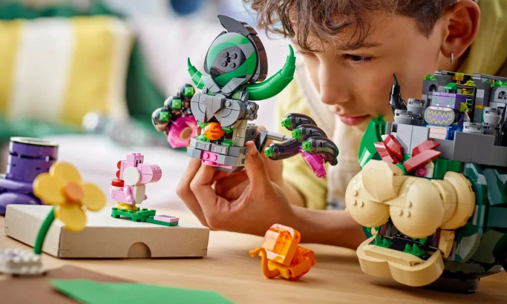 A boy playing with LEGO's Prince Florian and Castle Bowser set