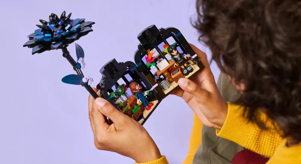 A person holding a LEGO Wednesday Black Dahlia set