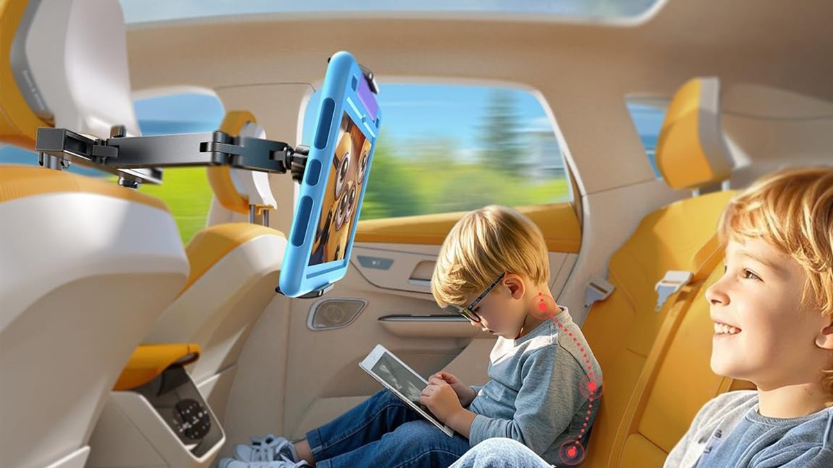 A child sitting in a car with a tablet