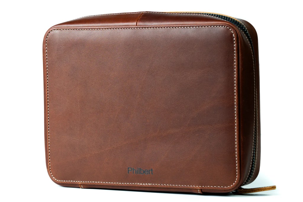 A brown leather bag with a zipper