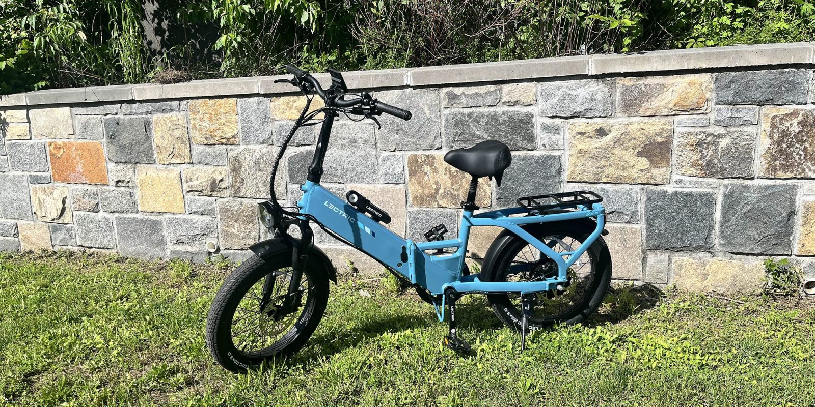 A blue bike parked in the grass