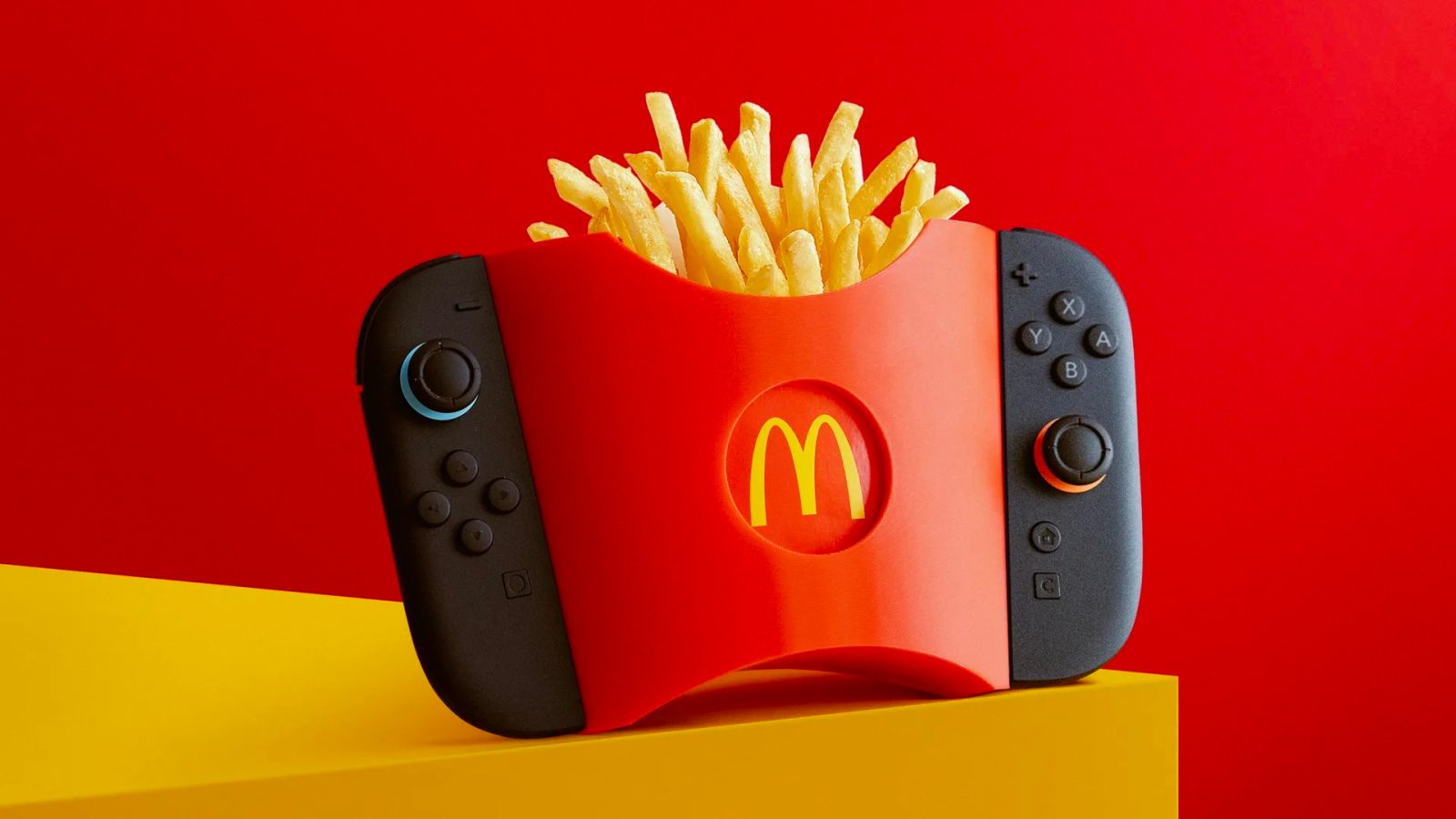A video game controller with a red and black box with french fries