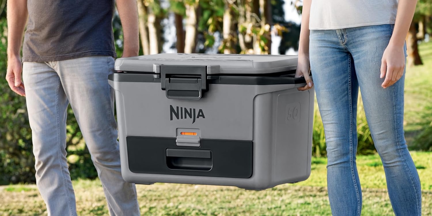 A man and woman holding a grey cooler