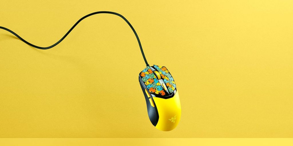 A yellow computer mouse with colorful designs
