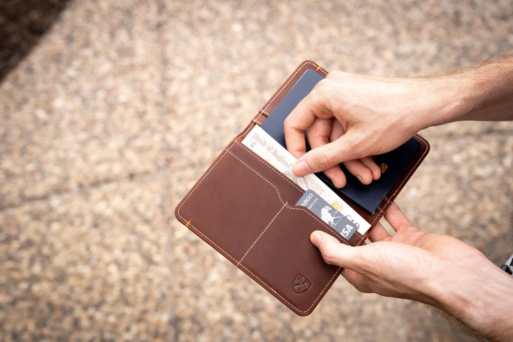 A person holding a wallet