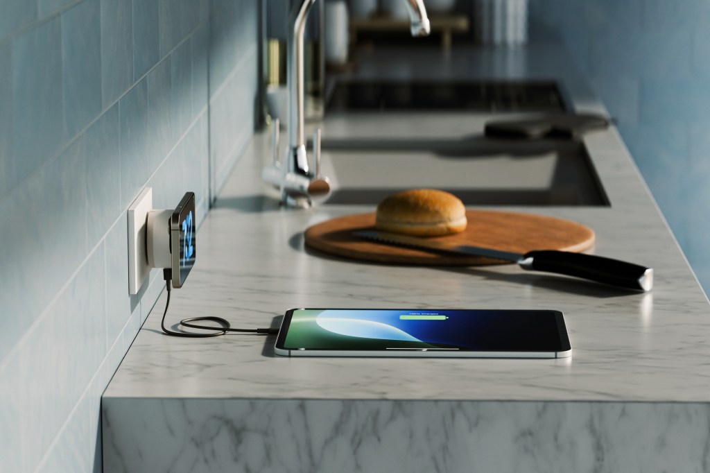 A cell phone charging on a counter