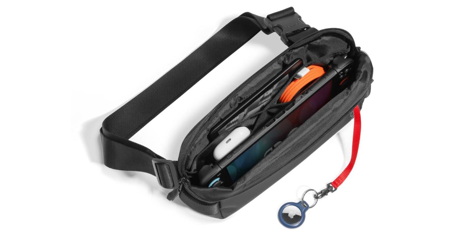 A black waist bag with a cell phone and a cord