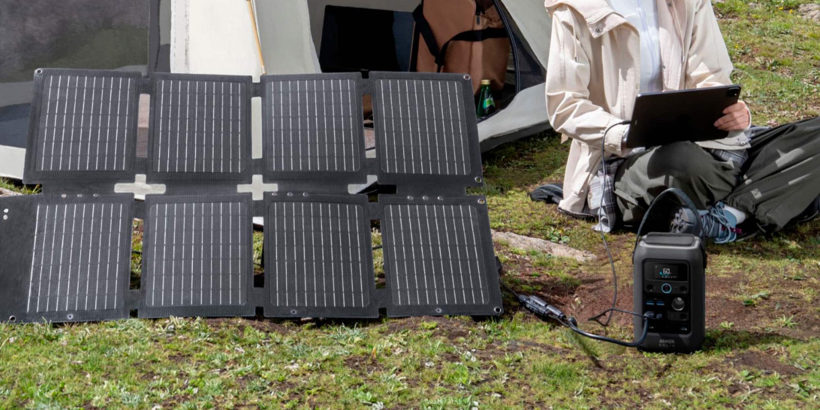 A solar panel next to a tent