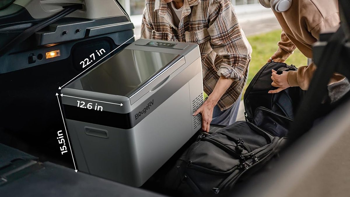 A group of people looking at a large printer
