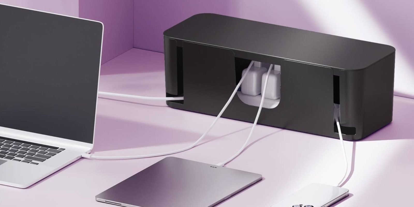 A black rectangular device with white wires connected to it