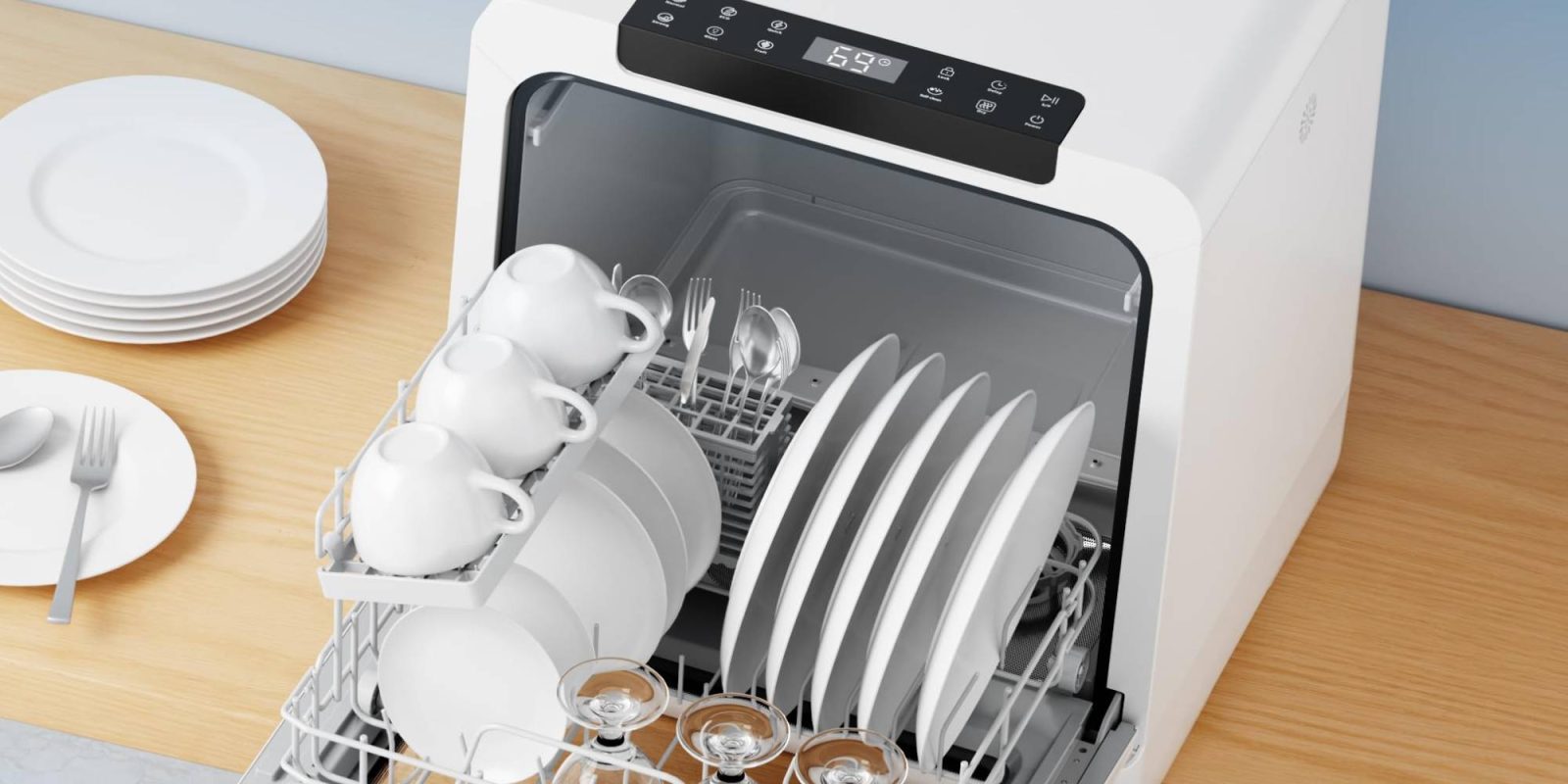 A dishwasher with plates and cups in it