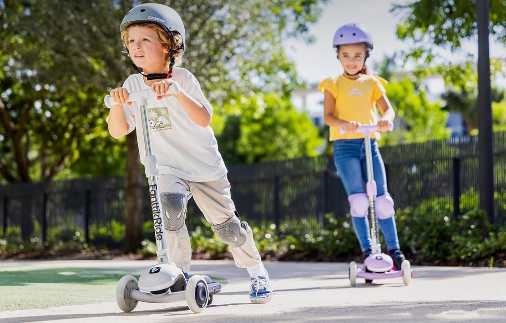 A boy and girl riding scooters