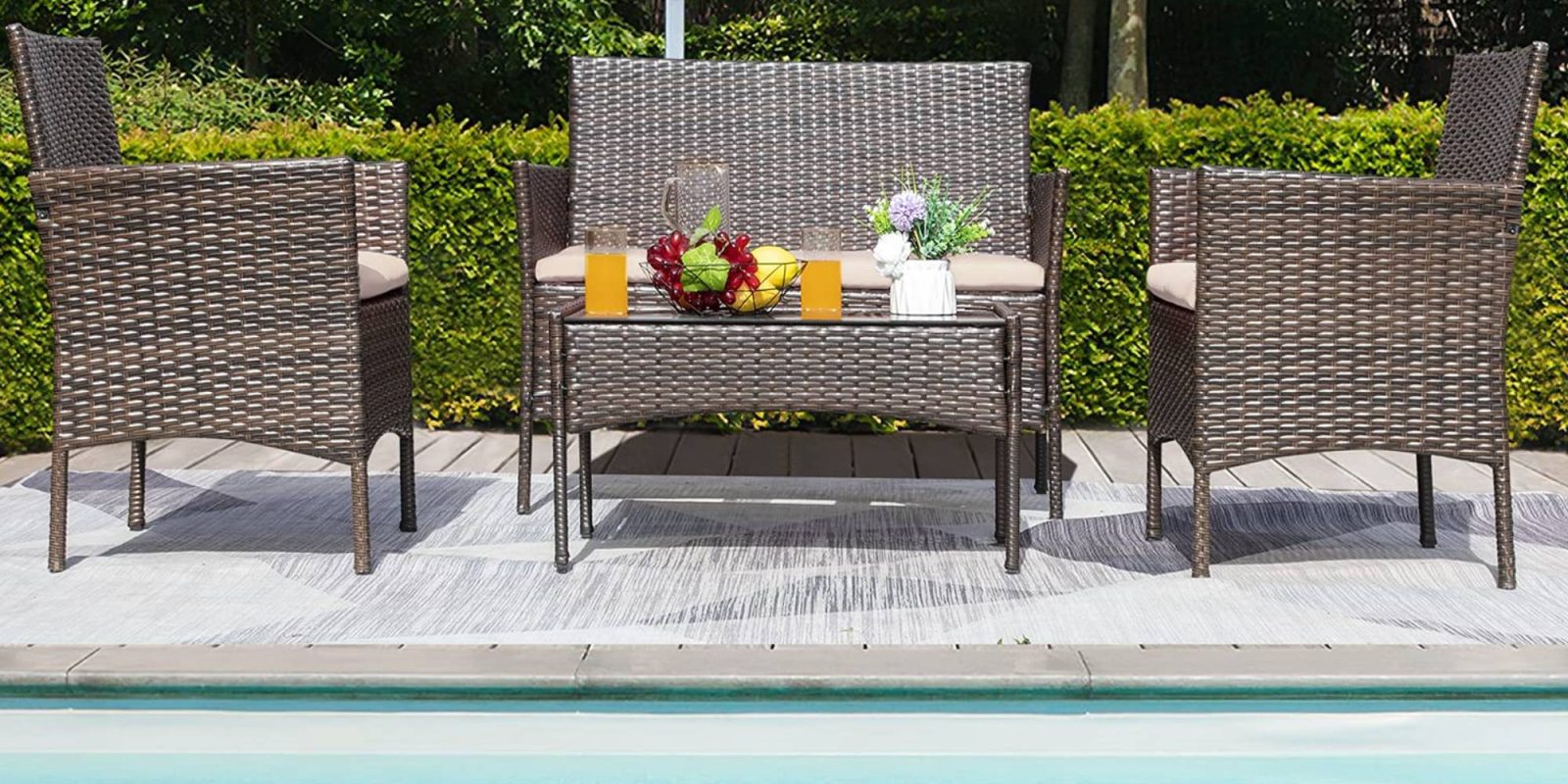A group of chairs and a table by a pool