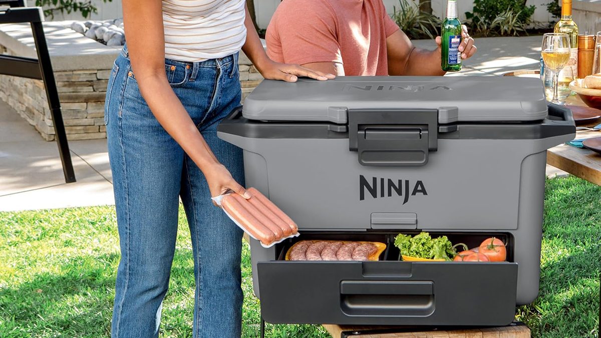 A man and woman standing next to a cooler