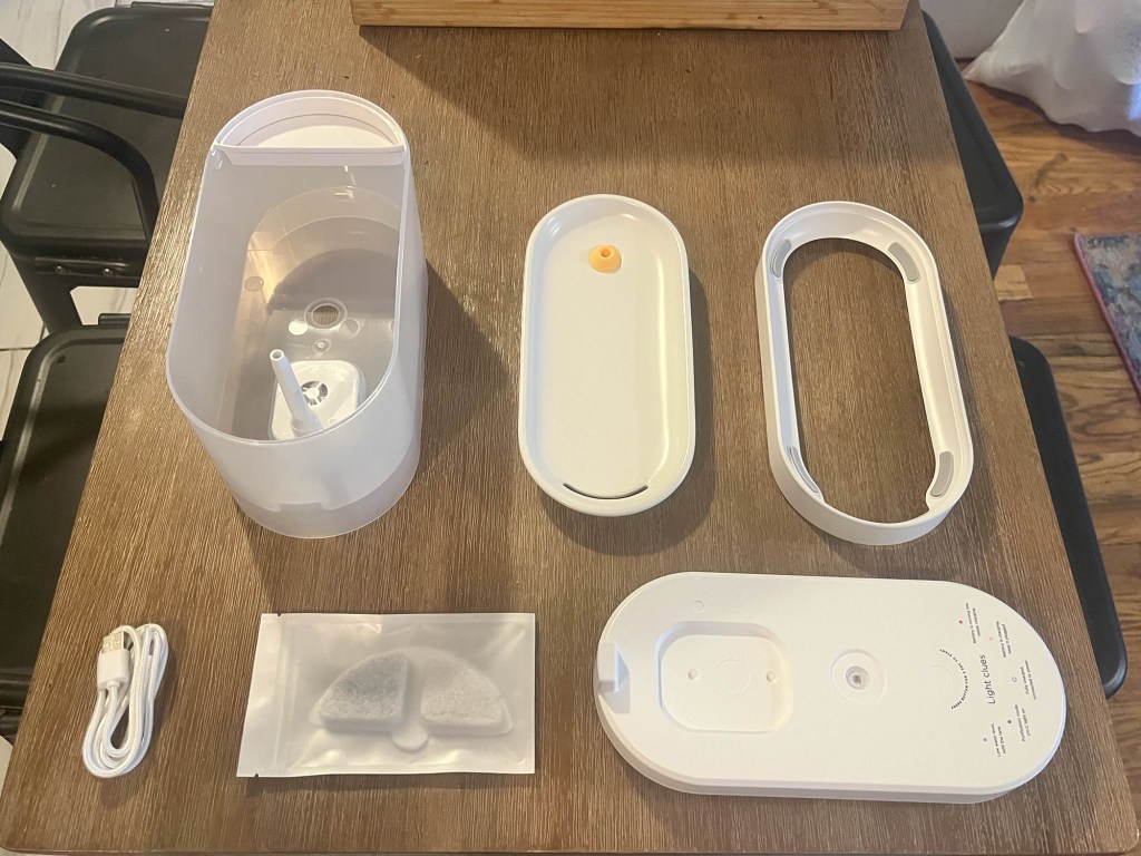 Petcube's Fountain seperated and spaced out on a table