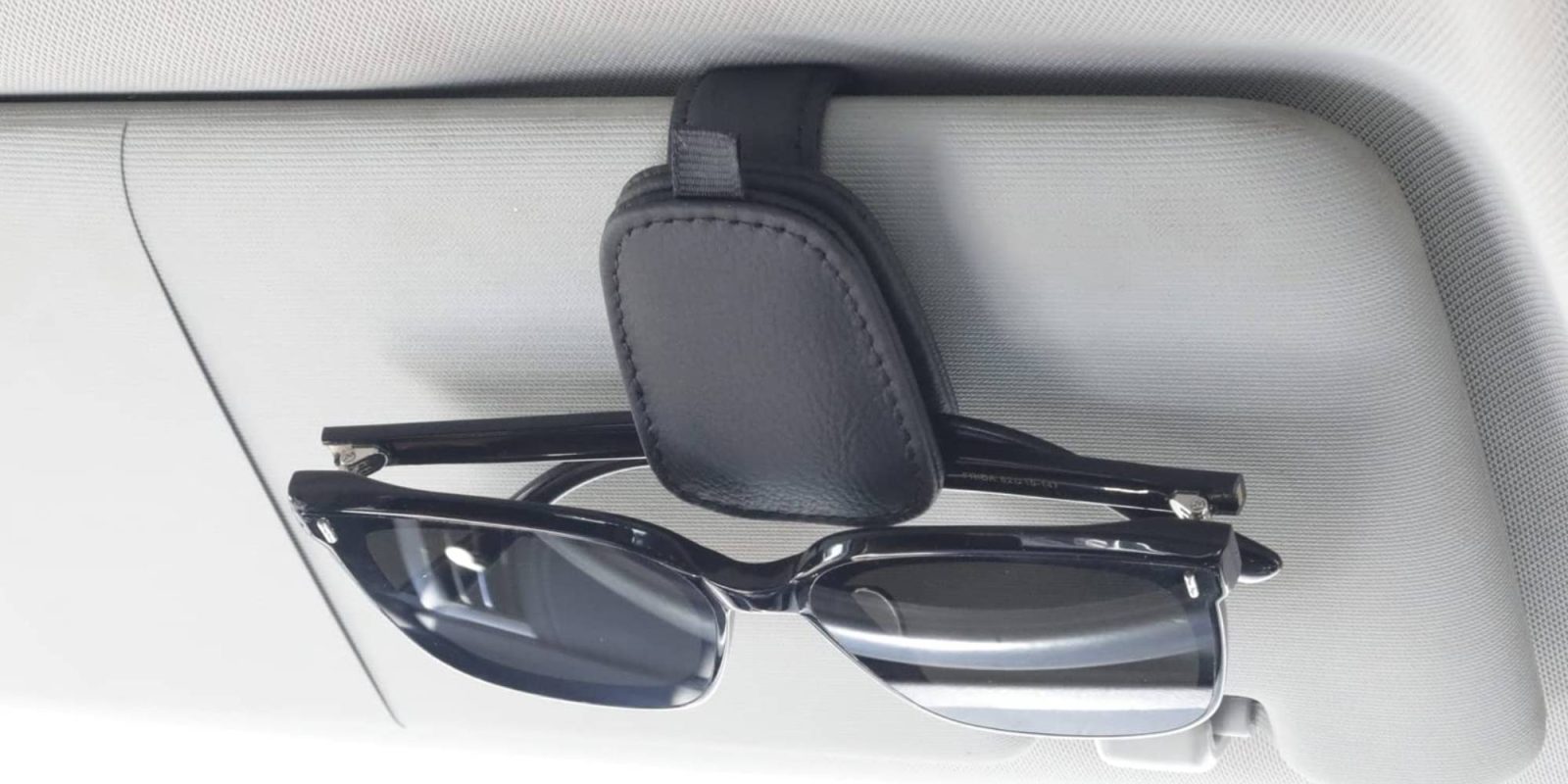 Sunglasses on a holder in a car