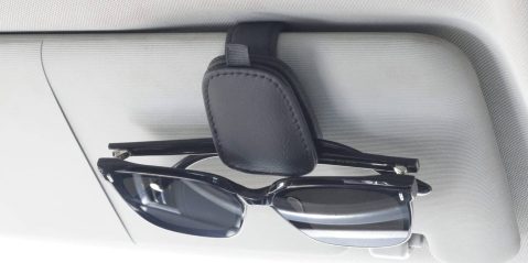Sunglasses on a holder in a car