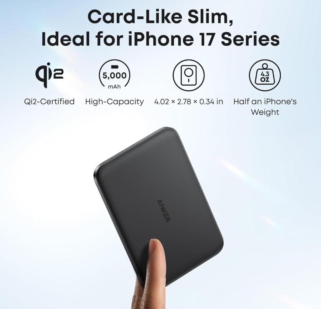 A hand holding a black rectangular device