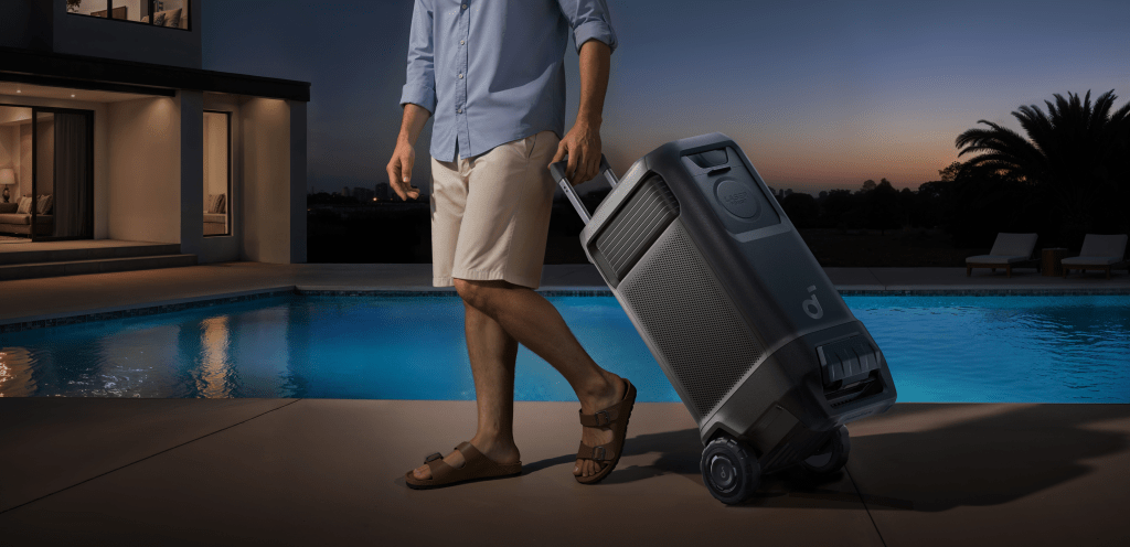 A man walking and pulling the Anker nebula x1 pro by handle