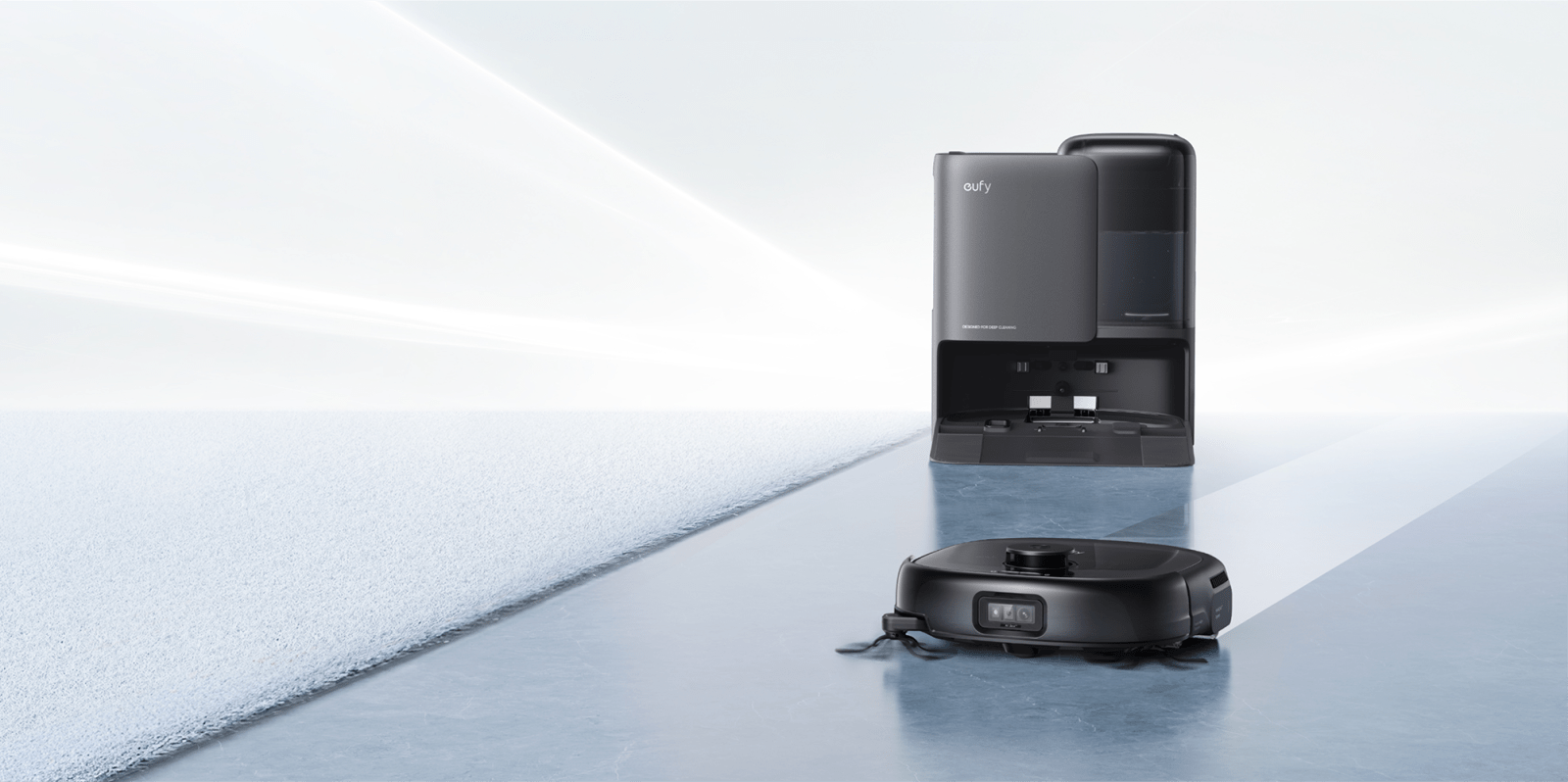 A robot vacuum cleaner next to a machine