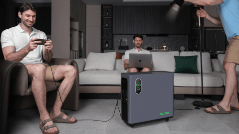 A man sitting on a couch with a laptop