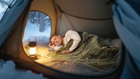 A man sleeping in a tent