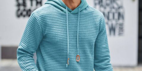 A man wearing a blue hoodie