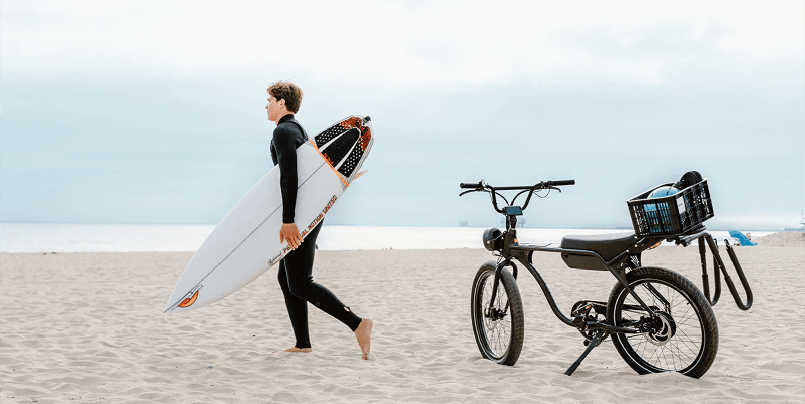 A man walking on the beach with a surfboard