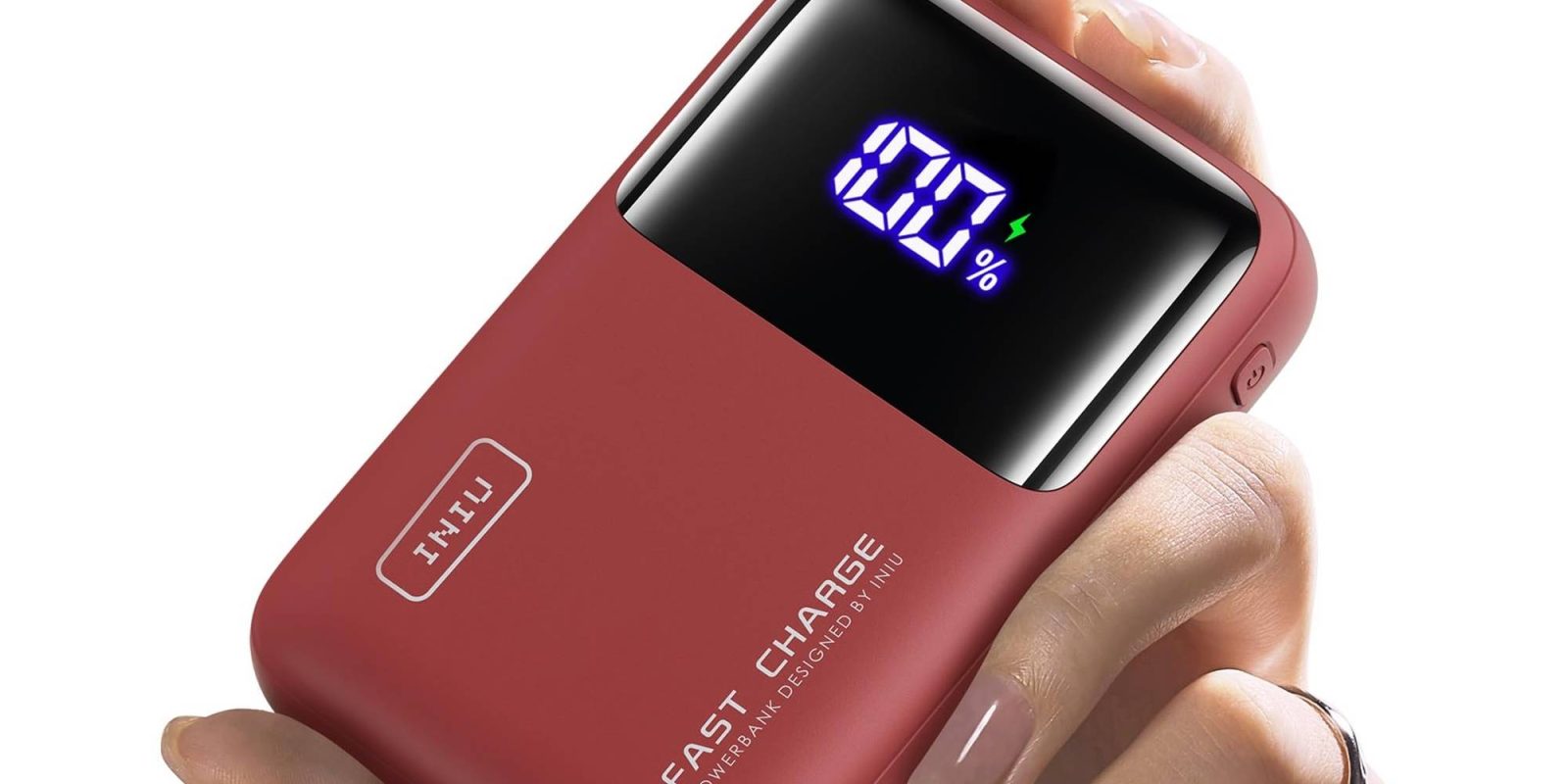 A hand holding a red battery