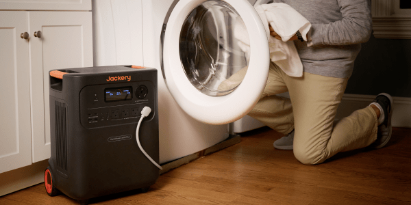 A person holding a white washing machine