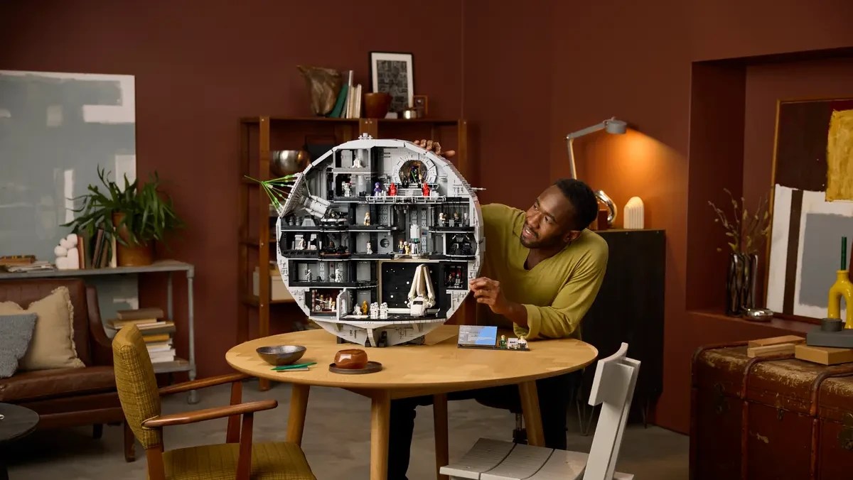 A man sitting at a table with a toy