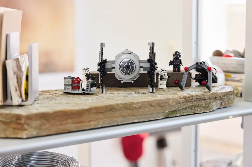 A group of lego toys on a wood surface