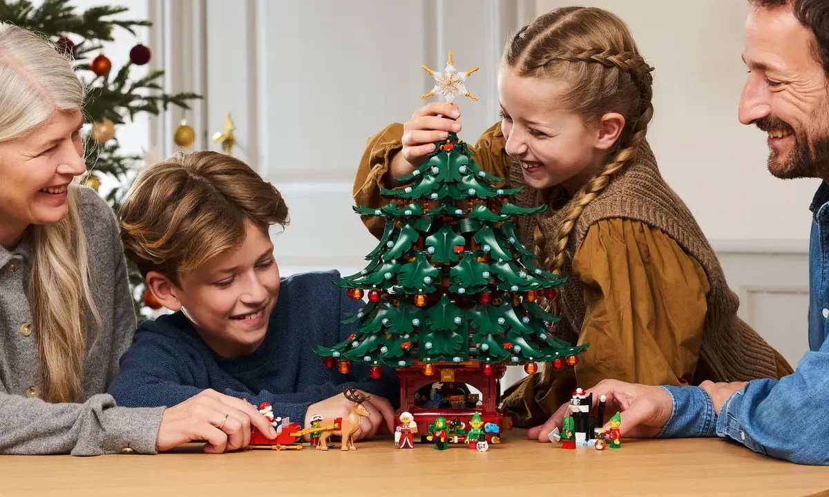 A boy and girl holding a christmas tree