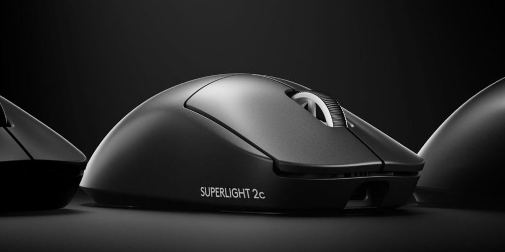 A black computer mouse on a black surface