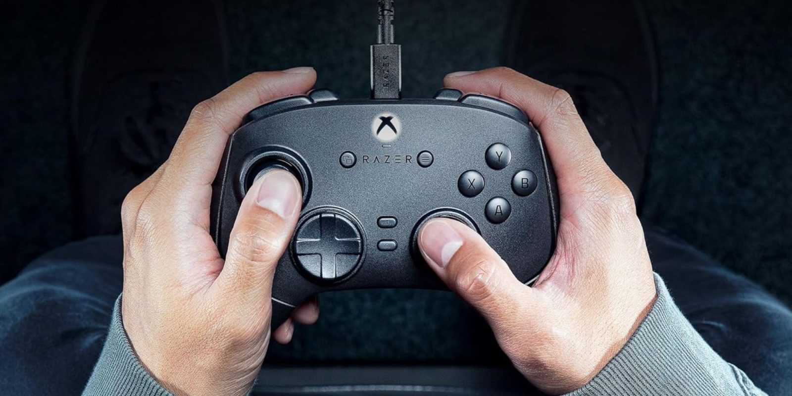 Hands holding a gaming controller