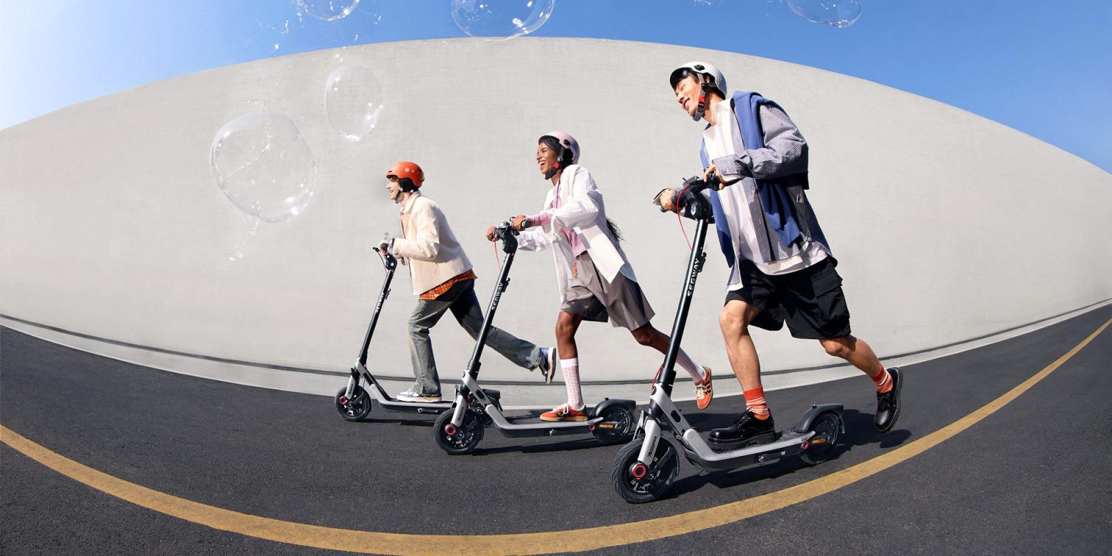 A group of people riding scooters