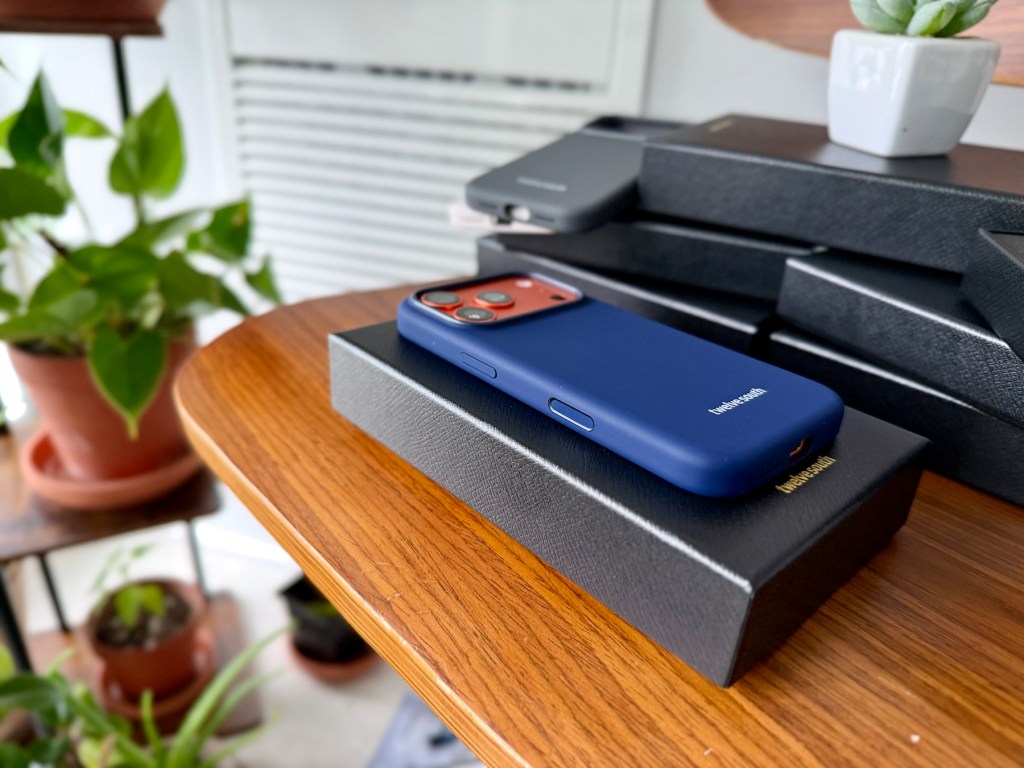 A blue cell phone on a black box on a table