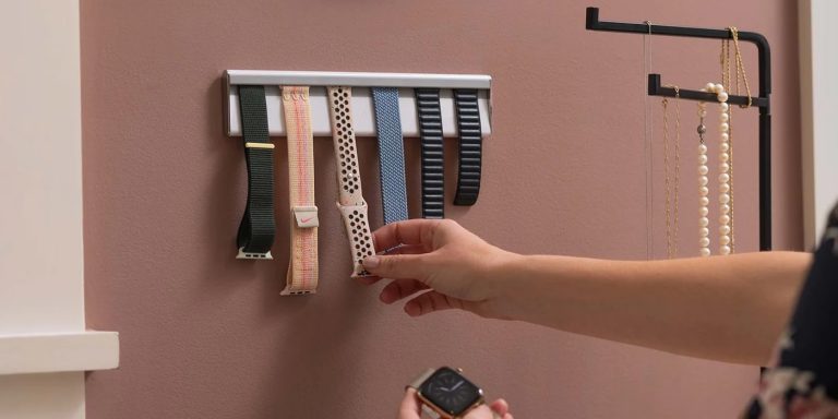 A person's hand holding a watch