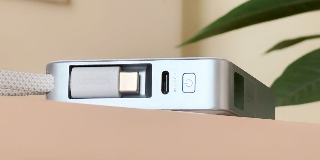 A close of UGREEN's MagFlow Qi2 25W power bank button.