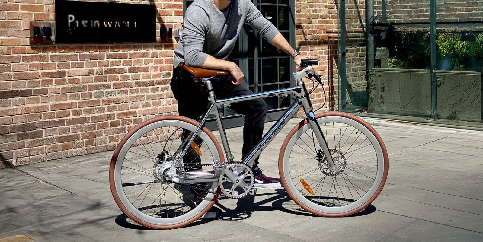 A man standing next to a bicycle