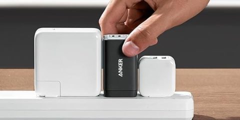 A hand holding a black and white device