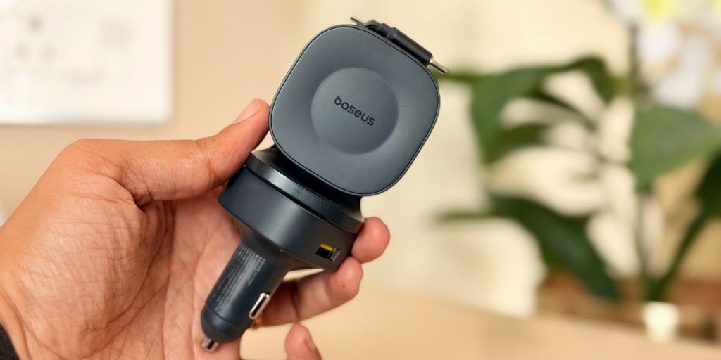 Image showing a person holding Baseus' 240W car charger.