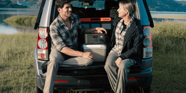 A man and woman sitting in the back of a car