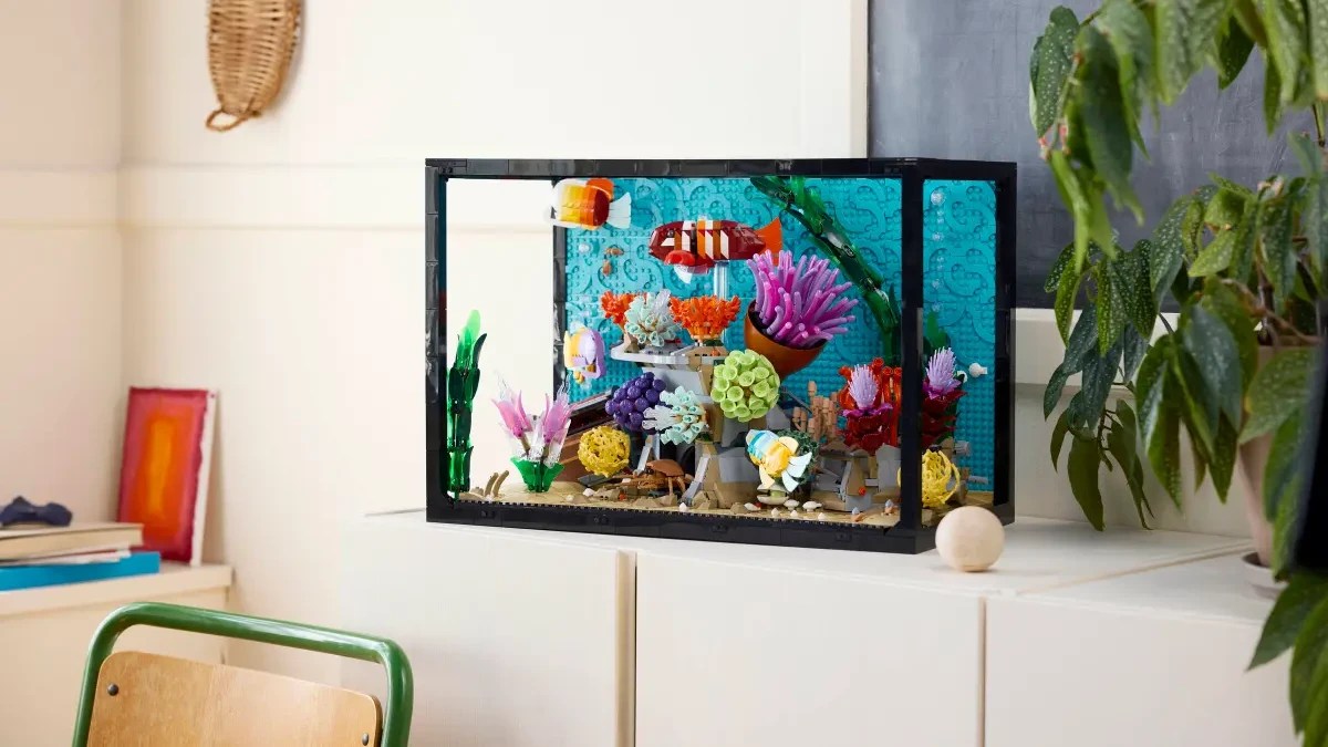 A fish tank with colorful objects on a white cabinet