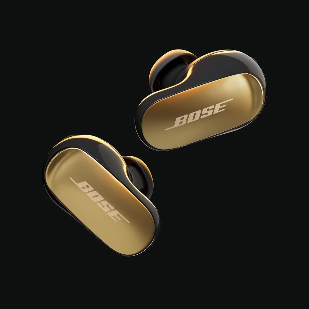A pair of black and gold earbuds